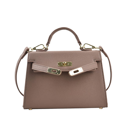 A woman carrying a small square bag with a lock
