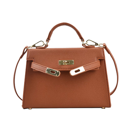 A woman carrying a small square bag with a lock