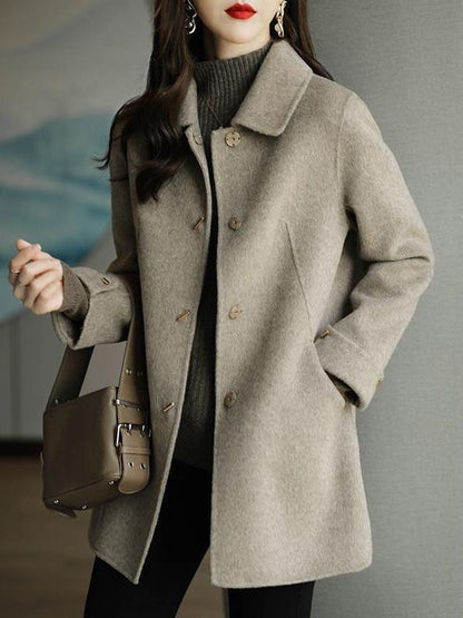 A woman wearing a woolen coat