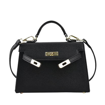 A woman carrying a small square bag with a lock